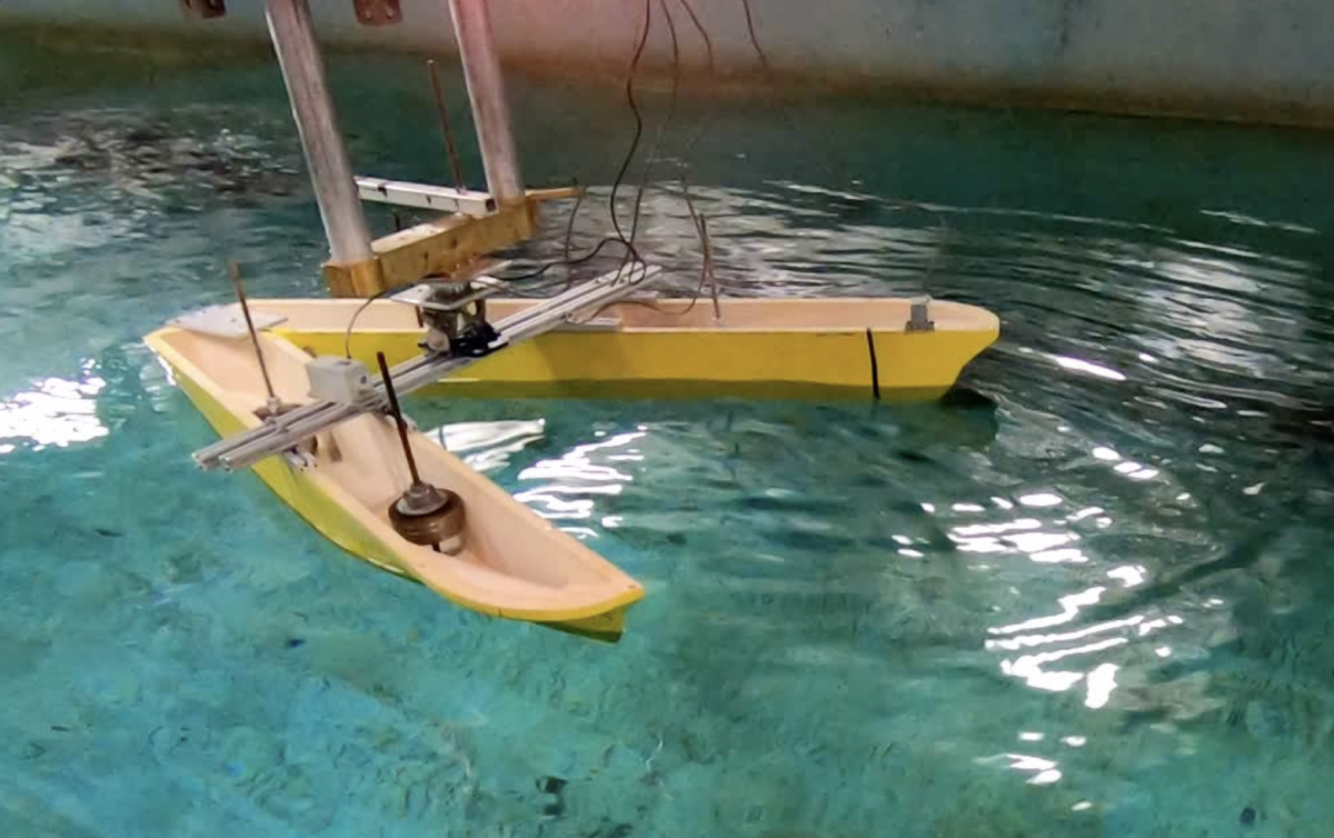 Prototype boat with its hull split into a "V" shape in Stevens' Davidson Lab wave tank