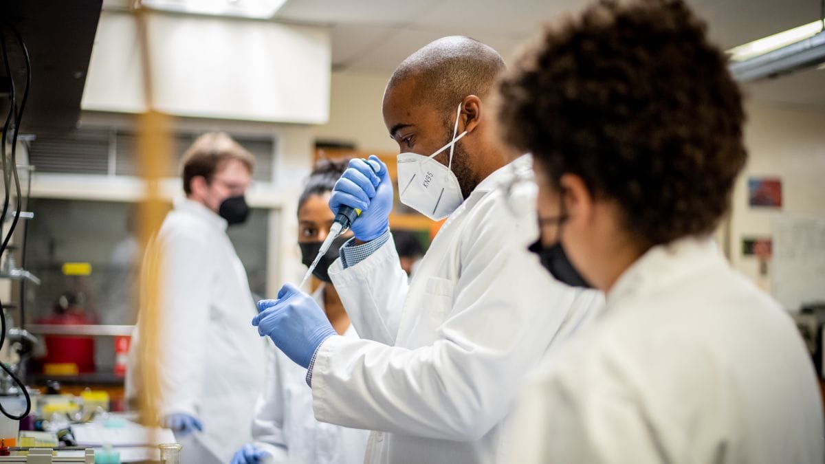 Students and instructor working in chemistry lab