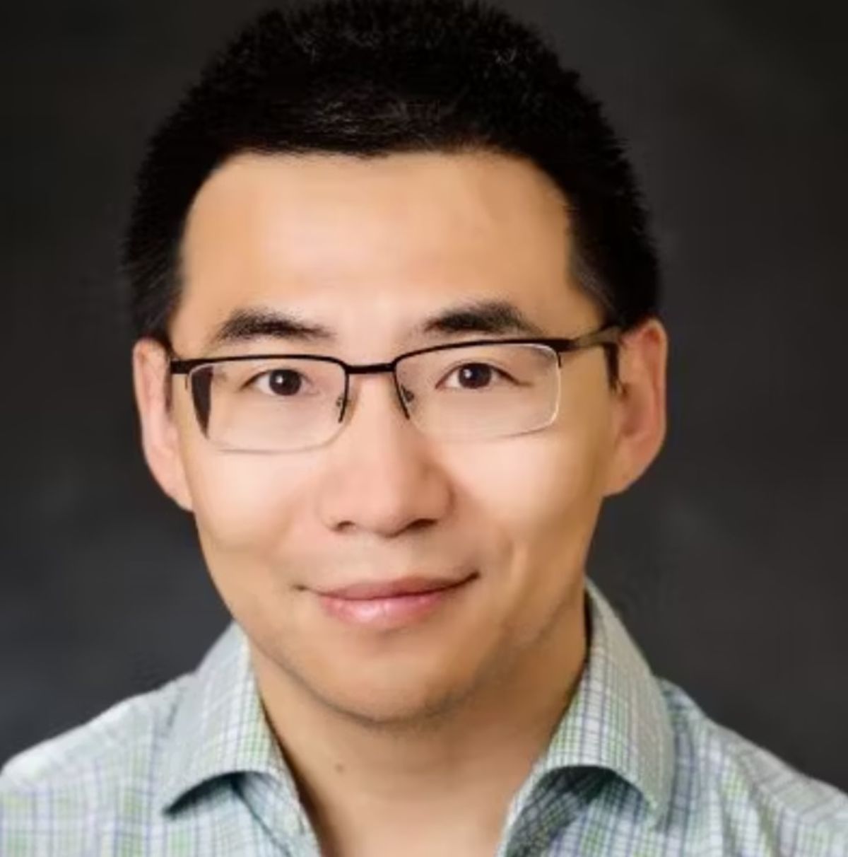 Headshot/professional portrait of Zhuo Feng, who is wearing a white collared shirt