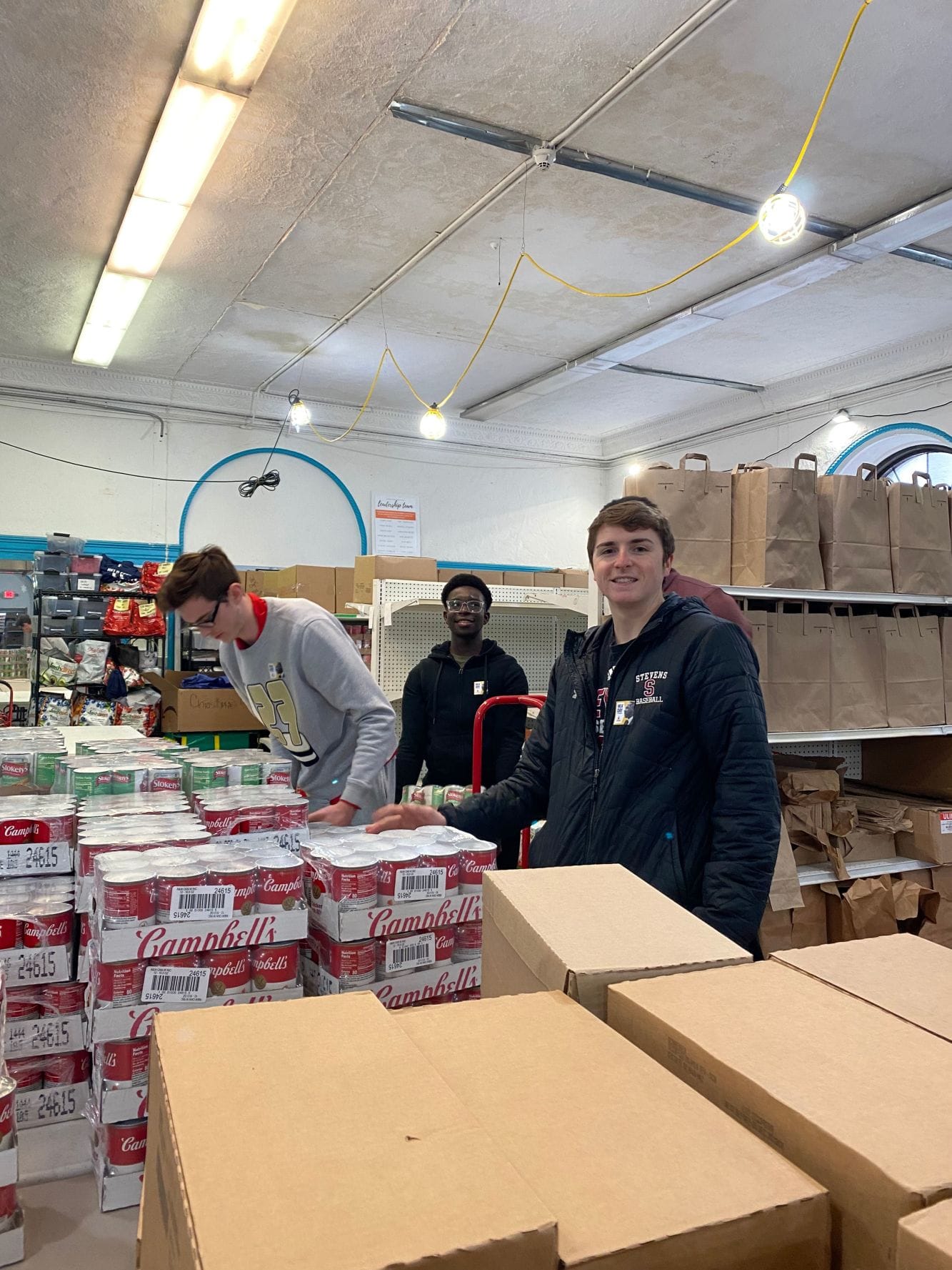 Students organizing canned food products at the Hoboken Food Pantry