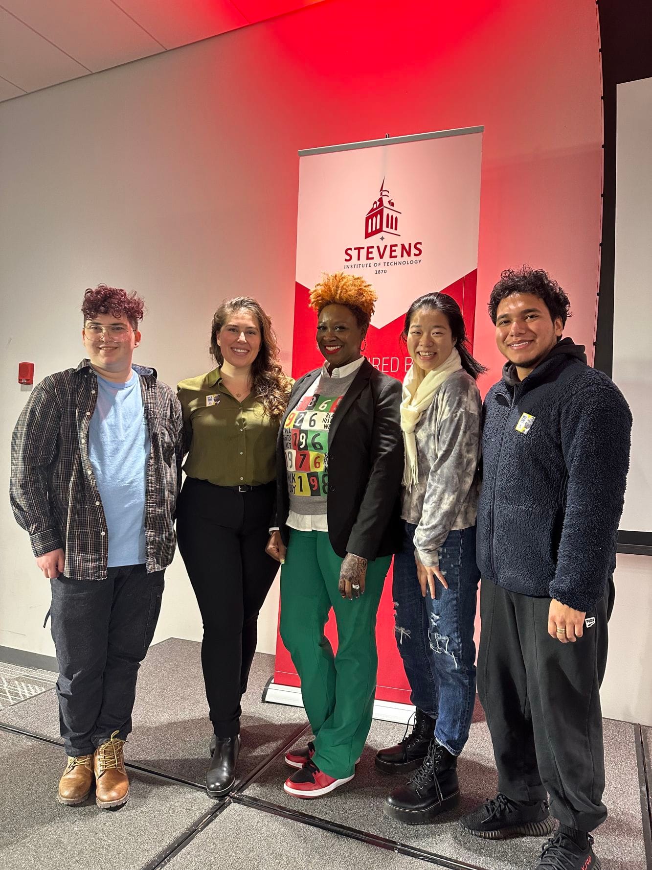 Stevens Director of Diversity, Equity and Inclusion Liliana Delman and keynote speaker Aisha Lawrey '99 pose with students 