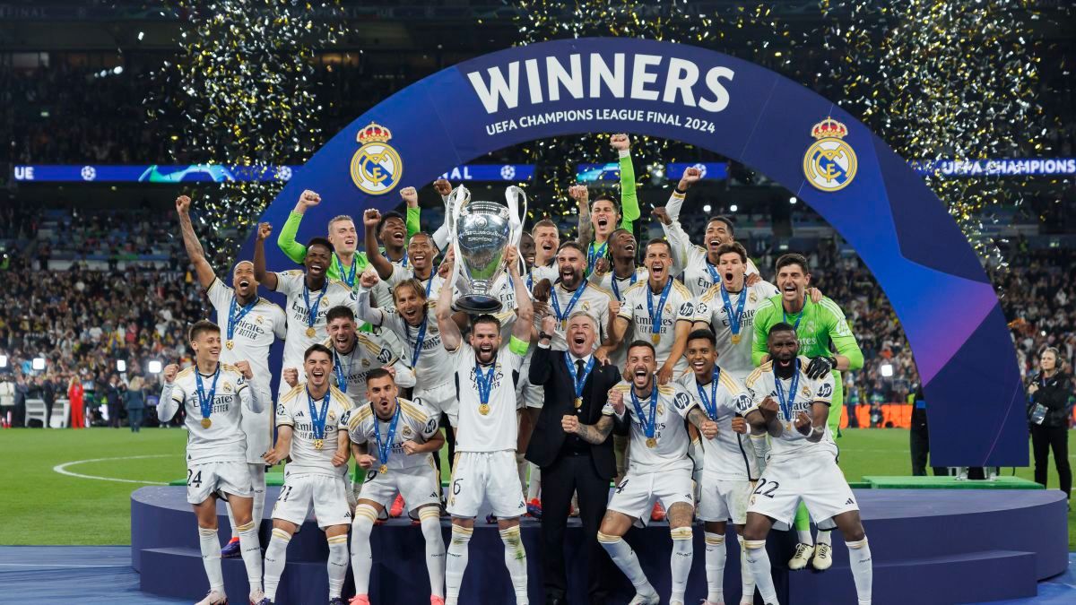 Real Madrid team holding up trophy