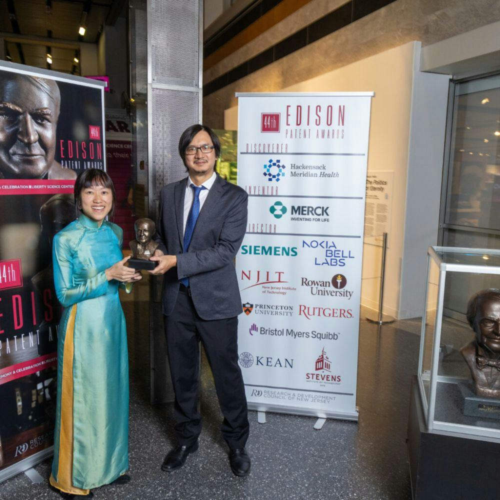 Stevens alumna Lac Nguyen and professor Yuping Huang pose with trophy at Edison Patent Awards Ceremony in November 2023