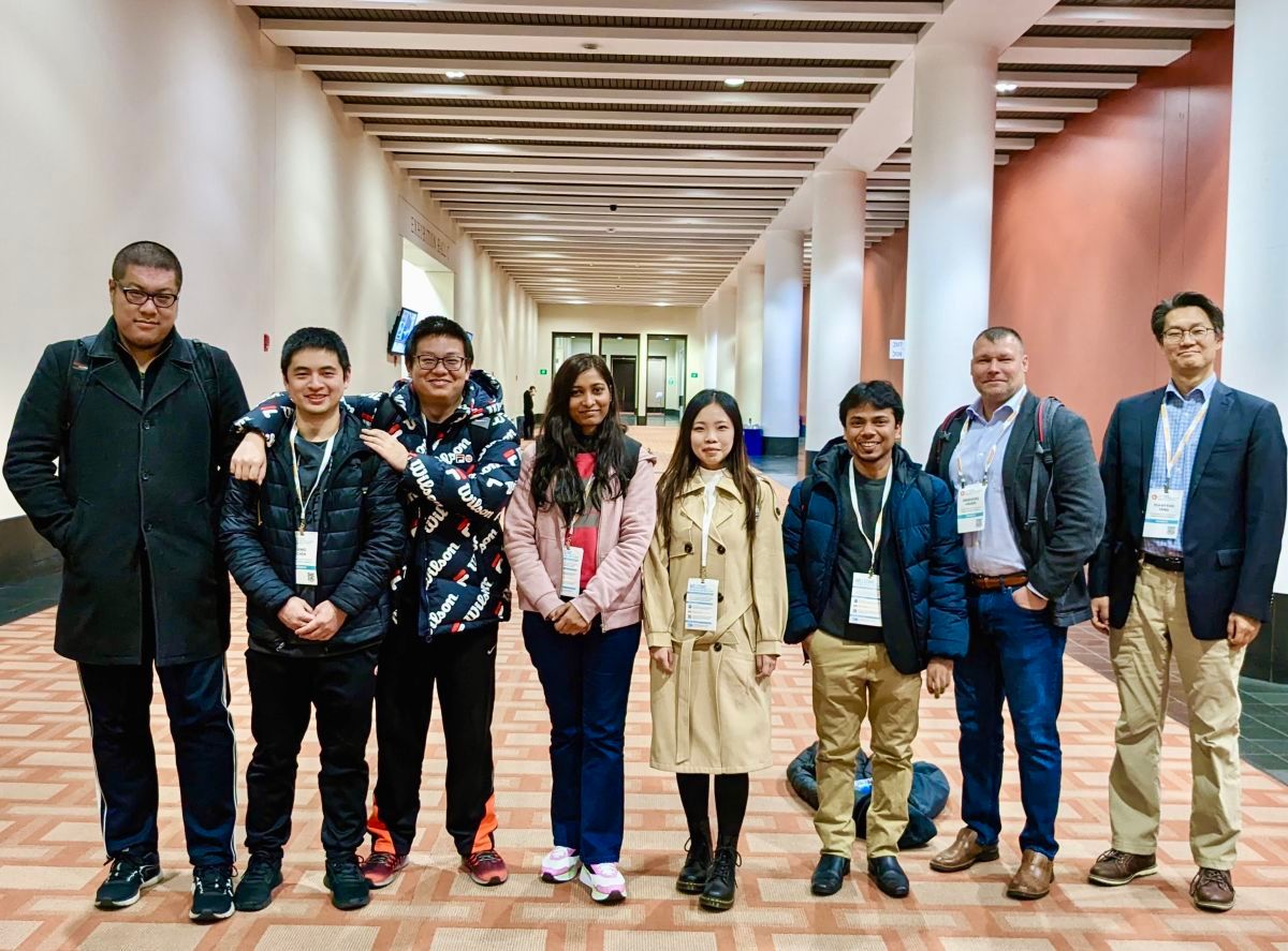 A photo of research students standing together in a lobby at the MRS Conference 