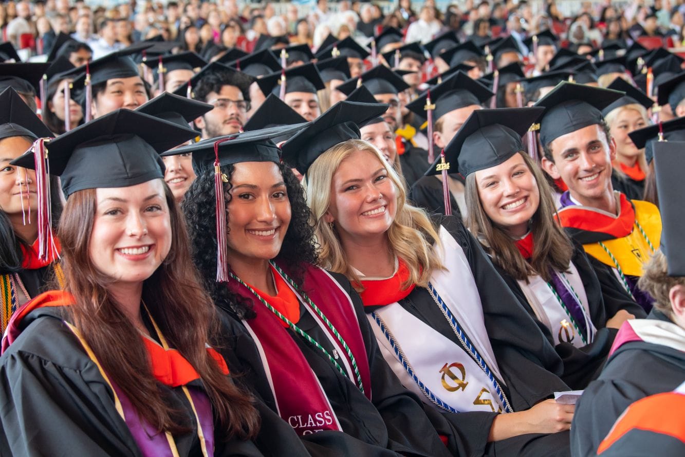 A line of grads smiles for the camera