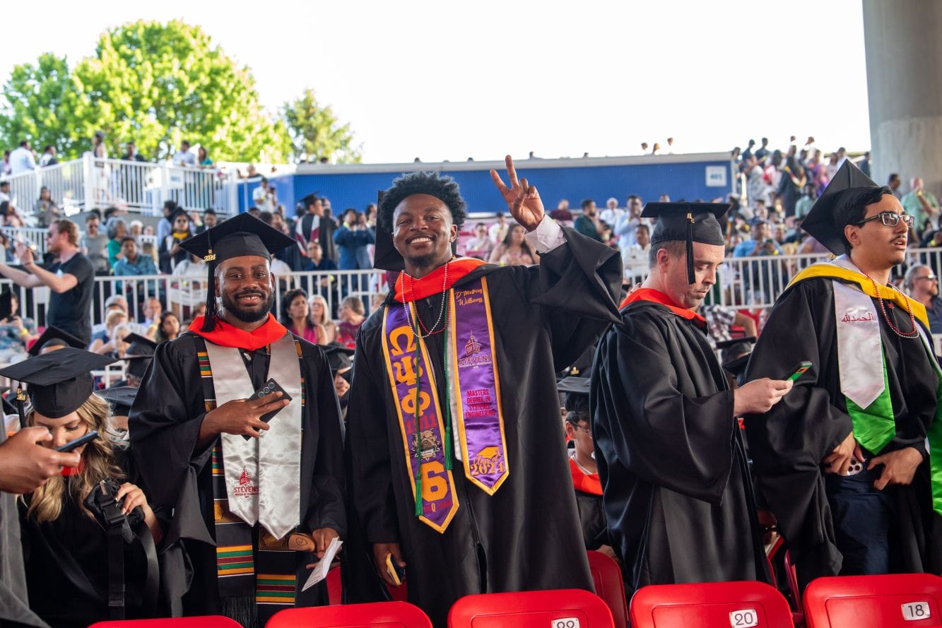 Master's graduates smile for the camera