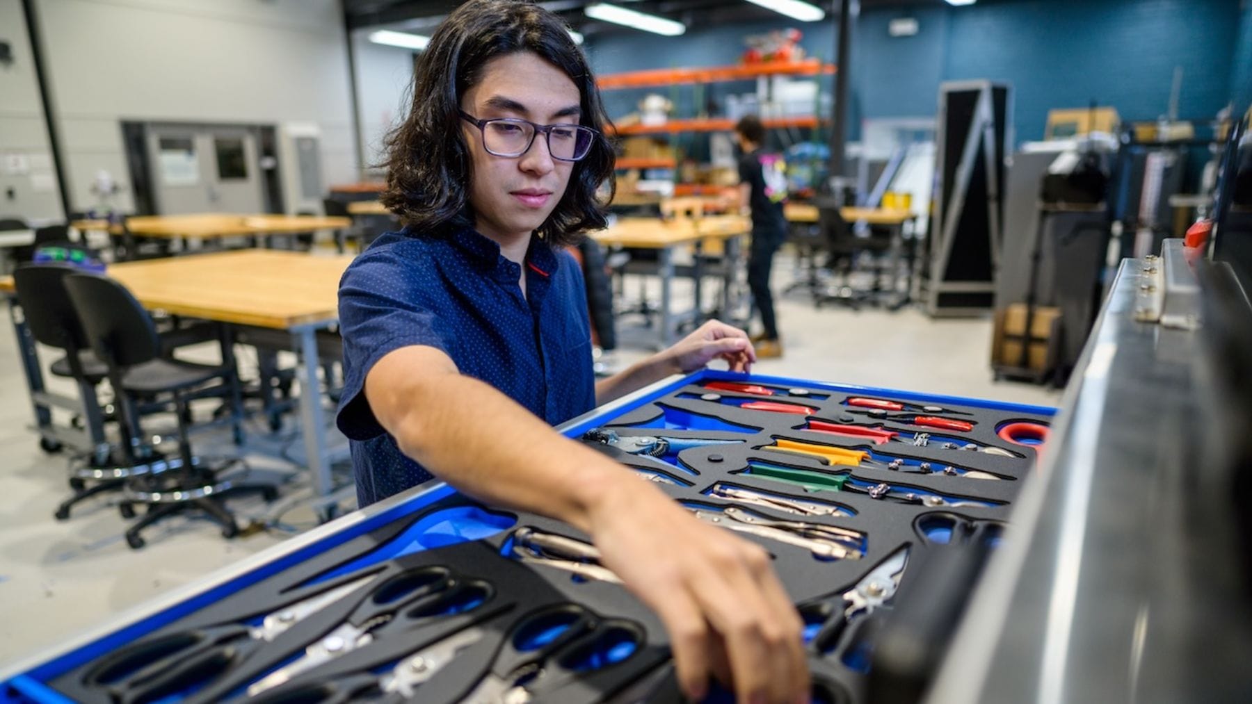 A student using the MakerCenter tool chest