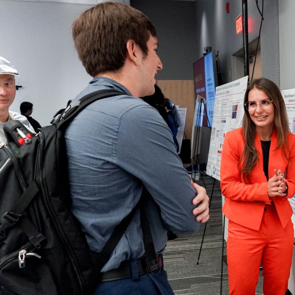 Stevens Ph.D. candidate Felicia Spadavecchia discusses her research with a fellow student.