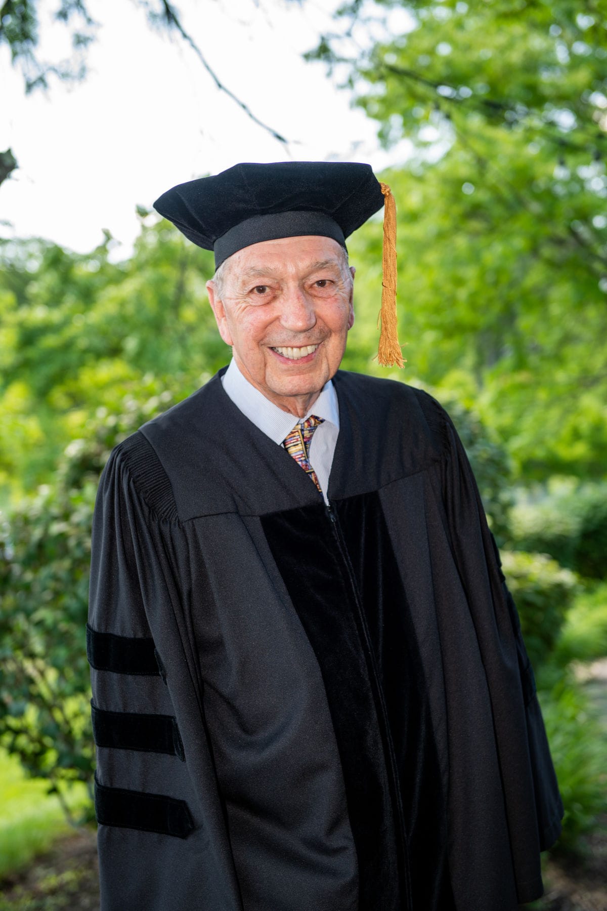 A portrait of a man dressed in academic regalia