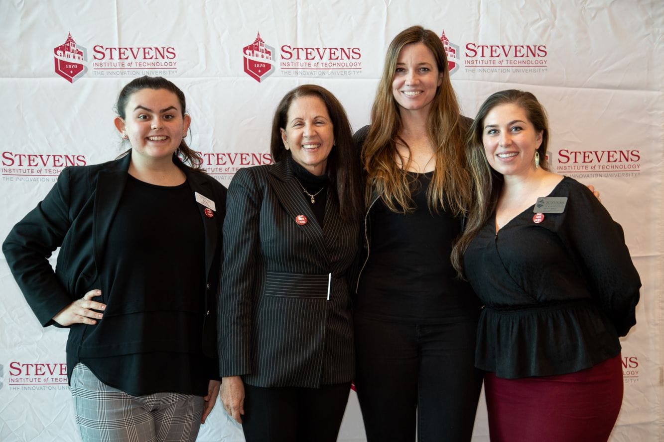 people post for a photo in front of stevens backdrop