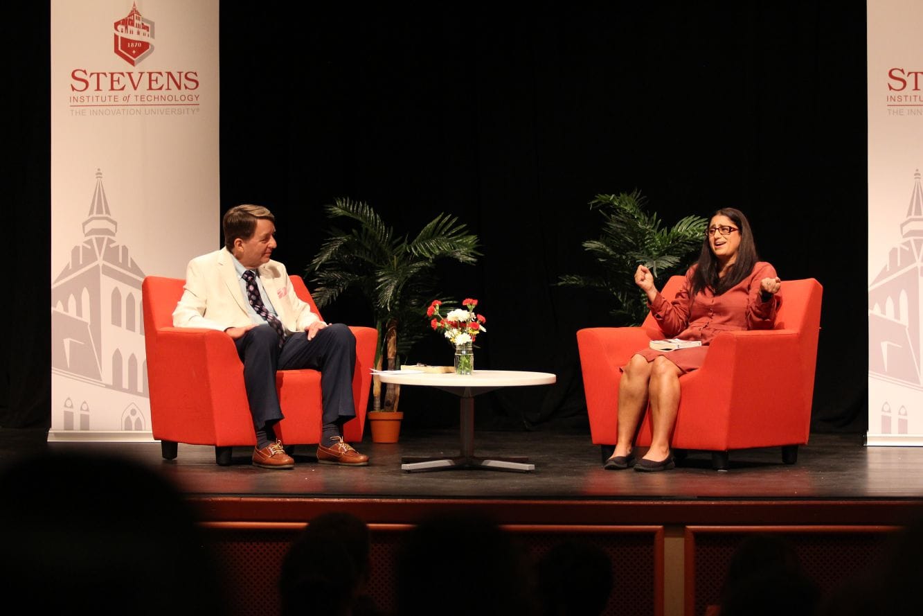 two people on stage talking with each other