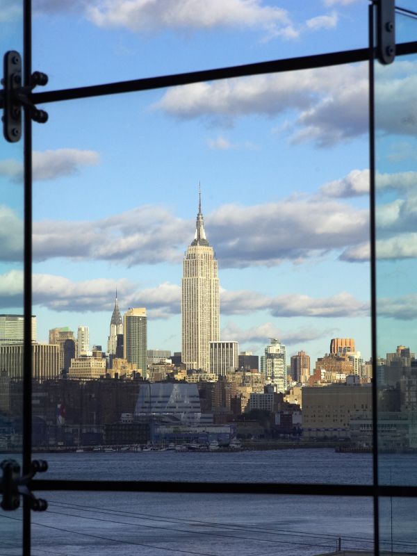 A view of lower Manhattan's skyline from Babbio's atrium. The shot is taken from inside the atrium, which consists of floor to ceiling windows.