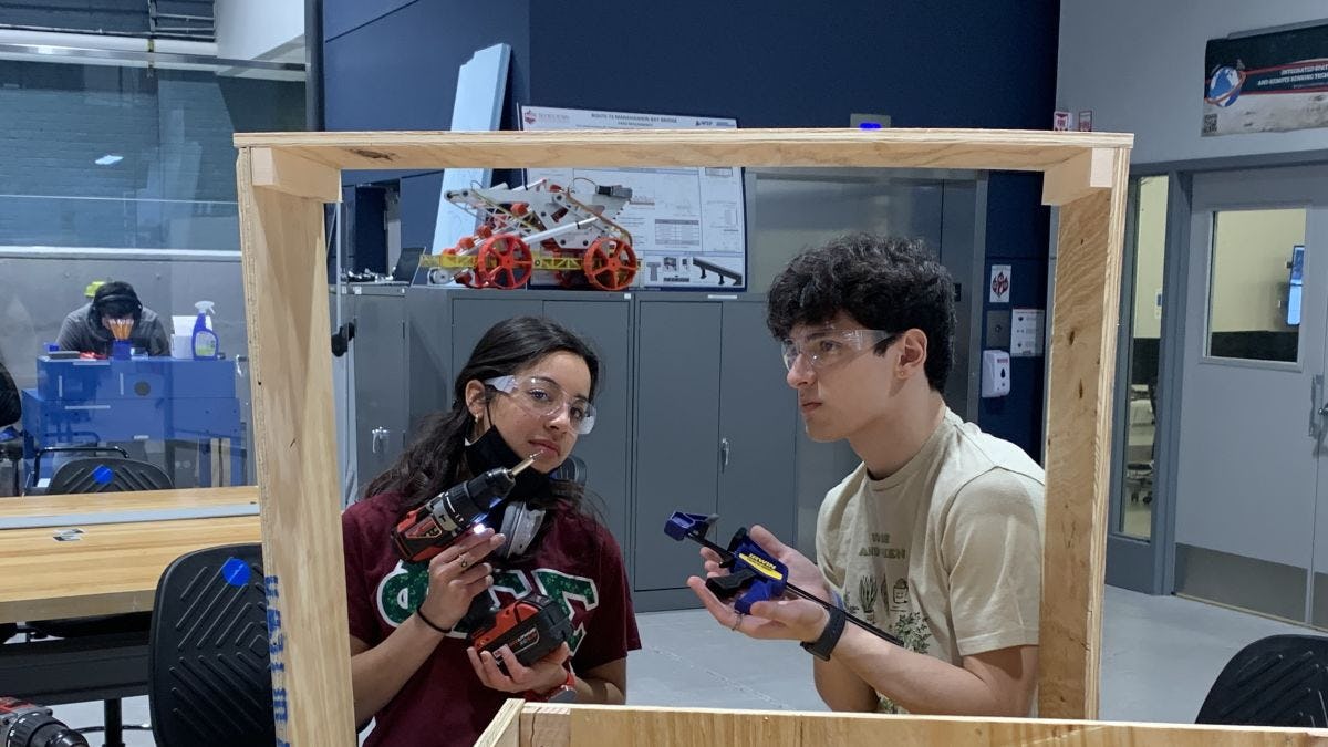 Intellliveggie team working on their smart greenhouse senior design project in the ABS engineering center