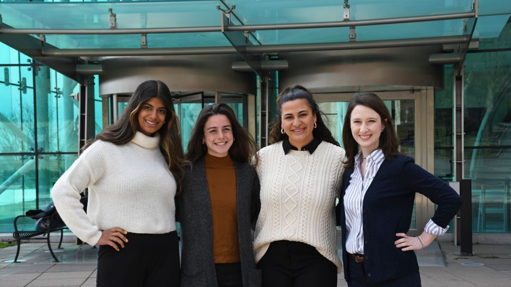 Four female students standing in front of Babbio Center.