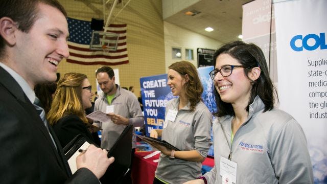 Student speaks with alum at the Career Fair 