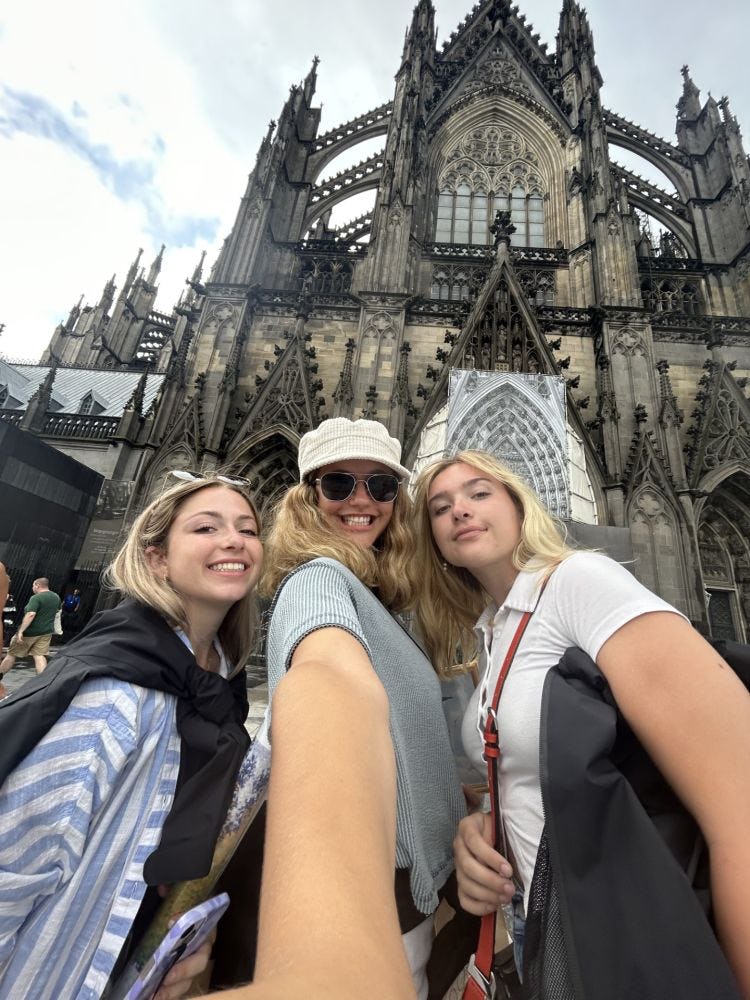 Three Stevens field hockey players pose for a selfie in front of a church during their summer 2023 trip