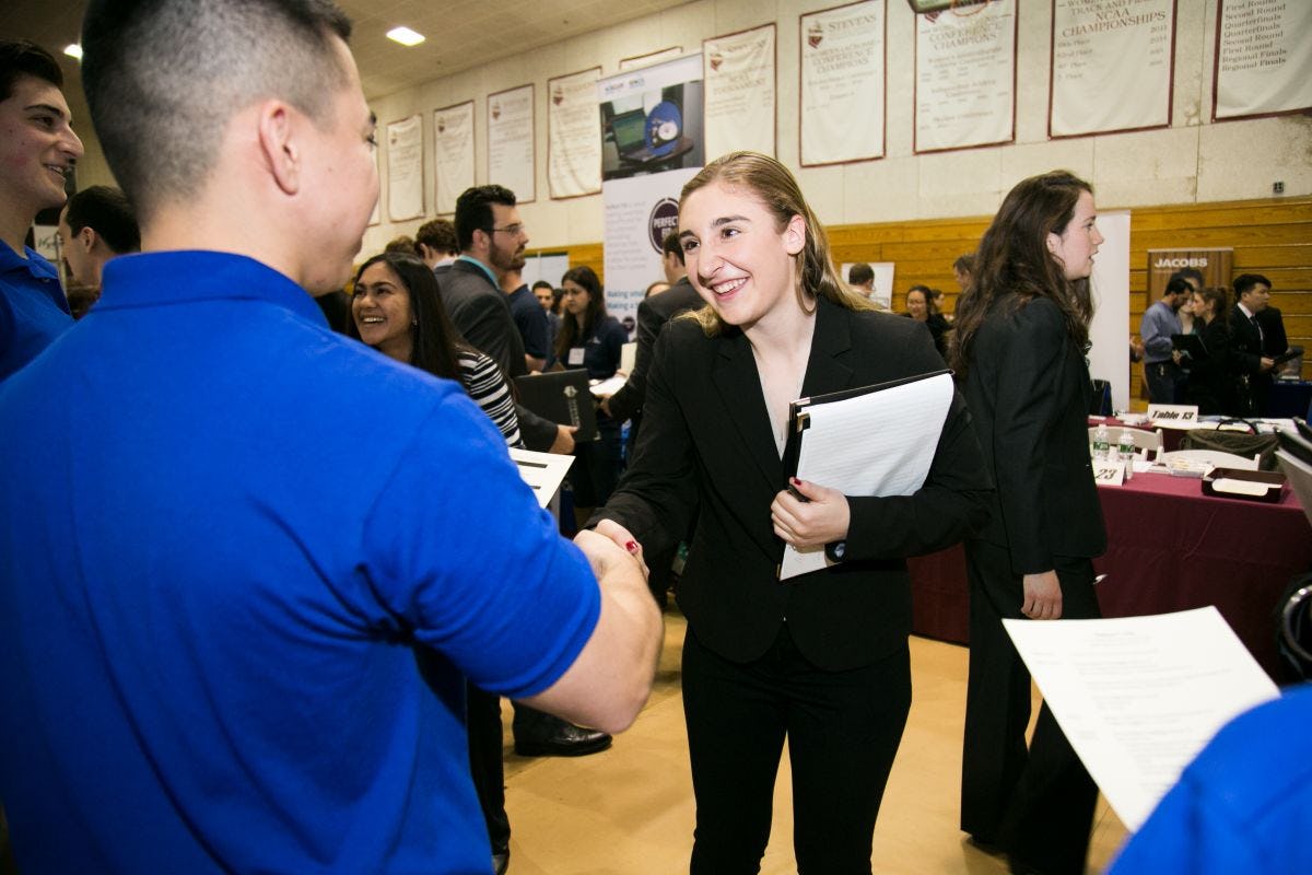 Student shakes hands with recruiter at Career Fair.