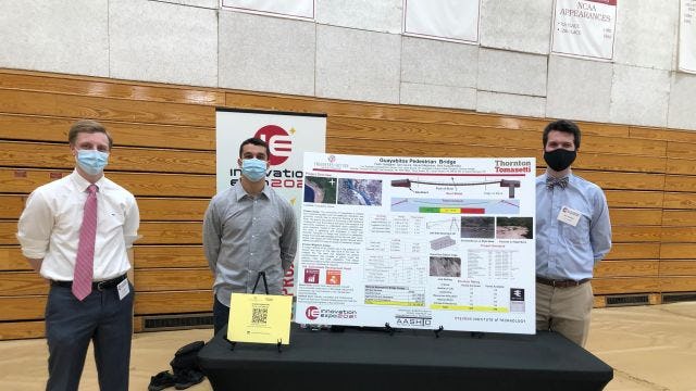 students with poster at Innovation Expo