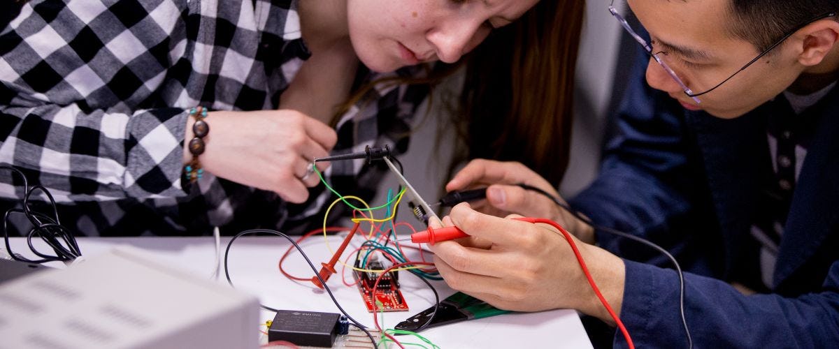 Two students working on wiring