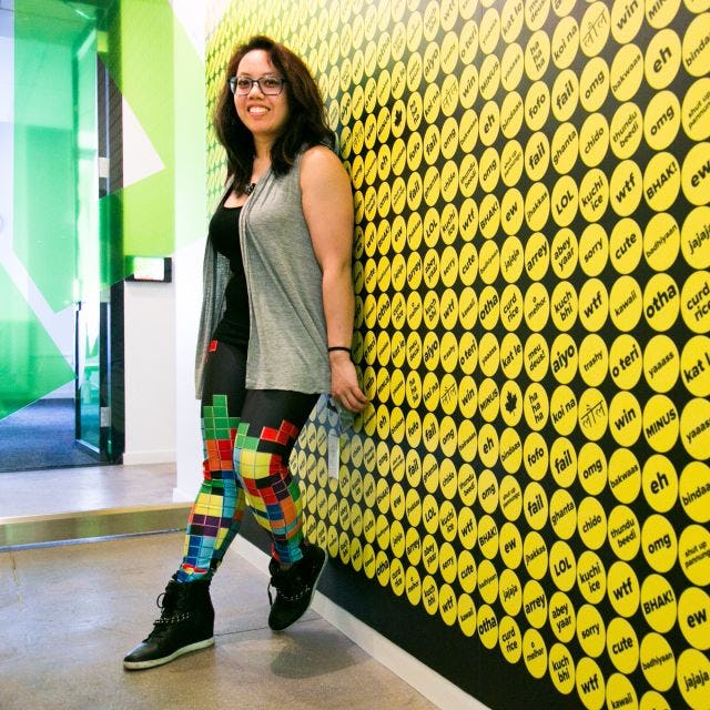 Caroline Amaba standing against a wall at Buzzfeed headquarters 