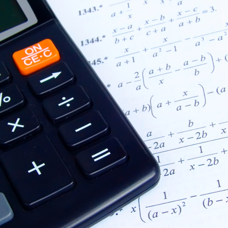 calculator on top of a sheet of paper with mathematical equations