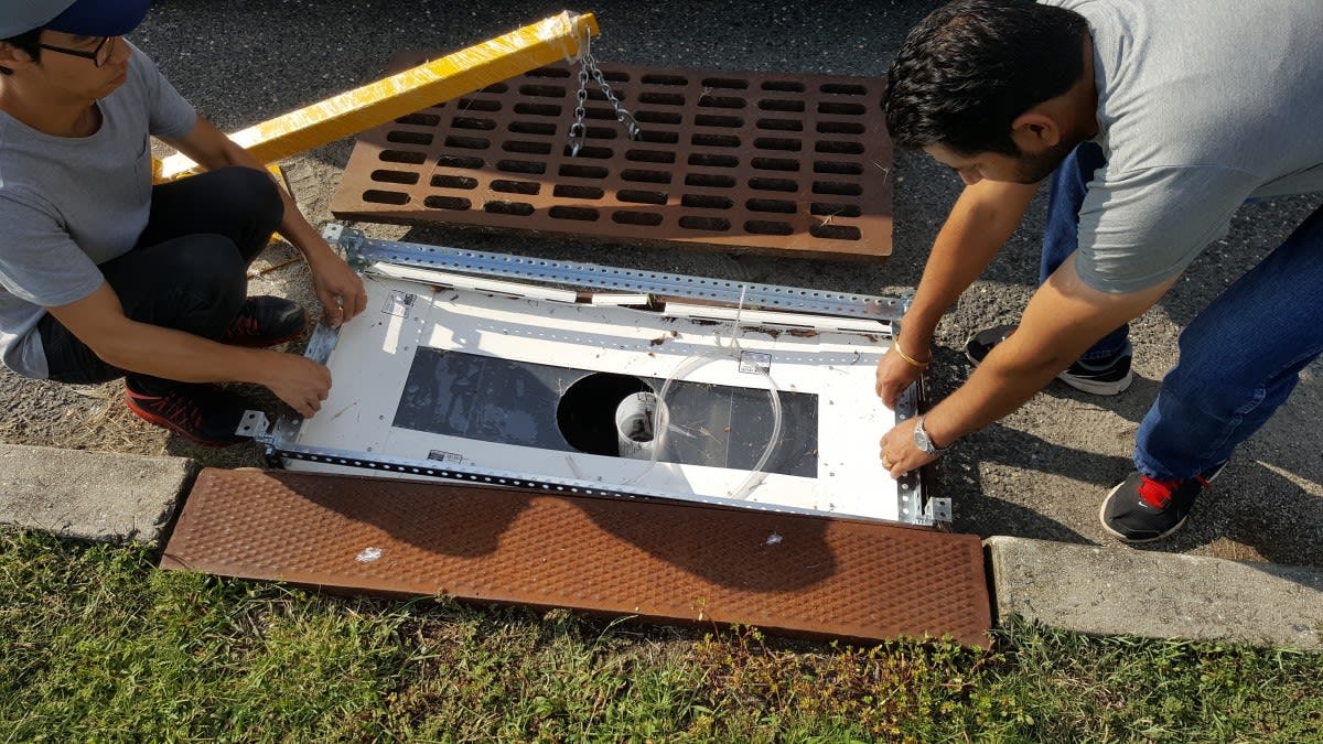 Students installing a drain