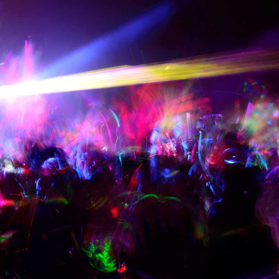 A stock visual of a dance party with glow sticks