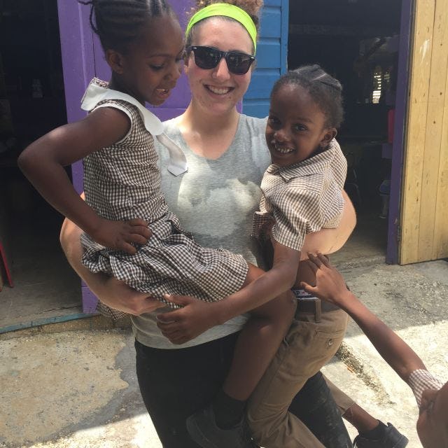 Olivia Schreiber in Jamaica holding 2 children