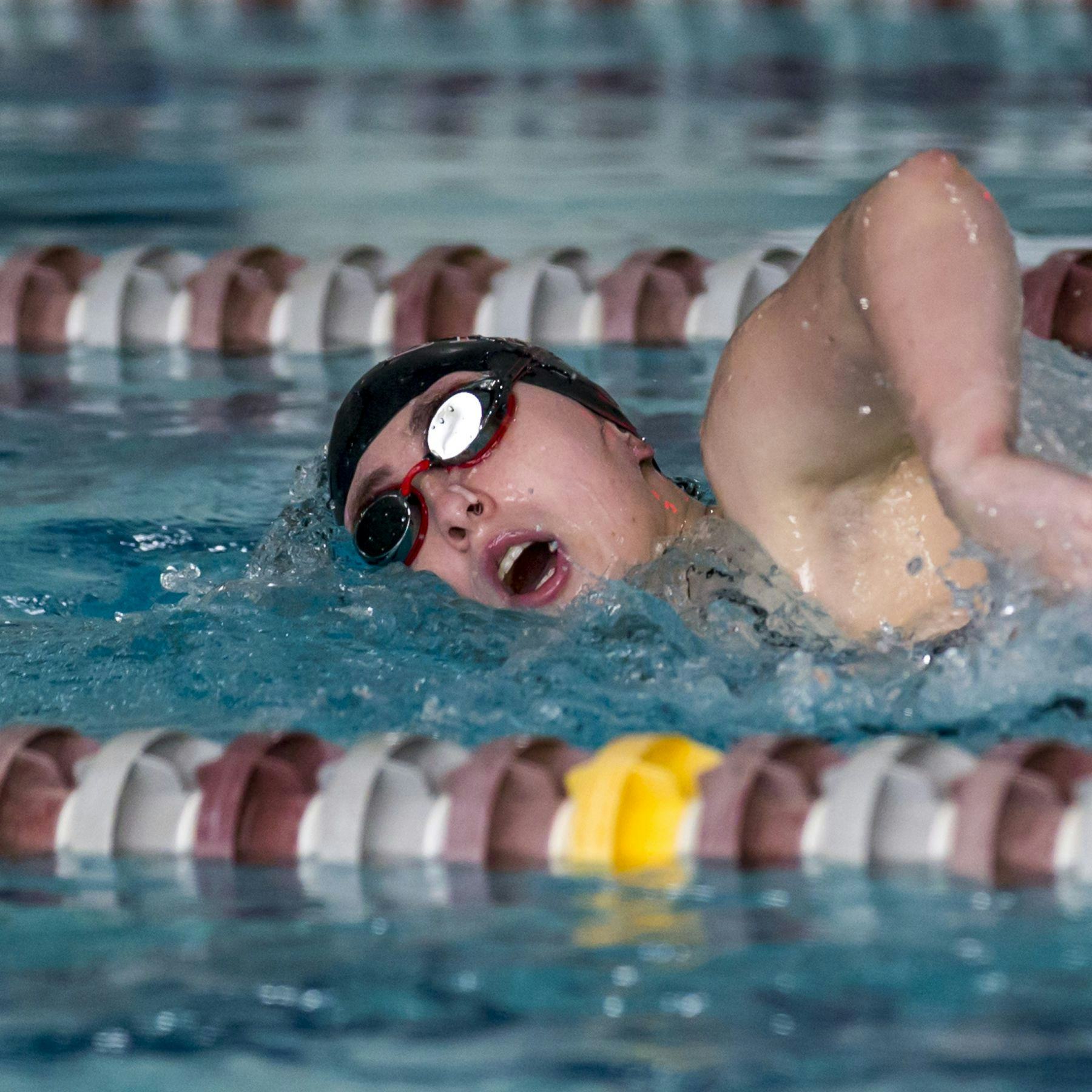 student swimmer competing in pool