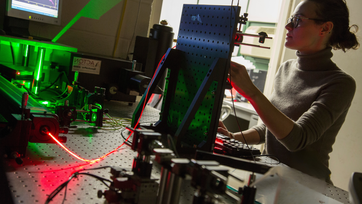 A female student working in a photonics laboratory  