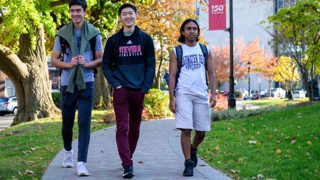3 male students walking on Campus