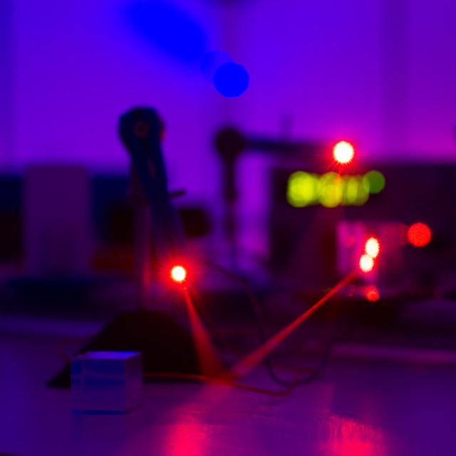 Laser beams in a photonics lab in the Department of Physics