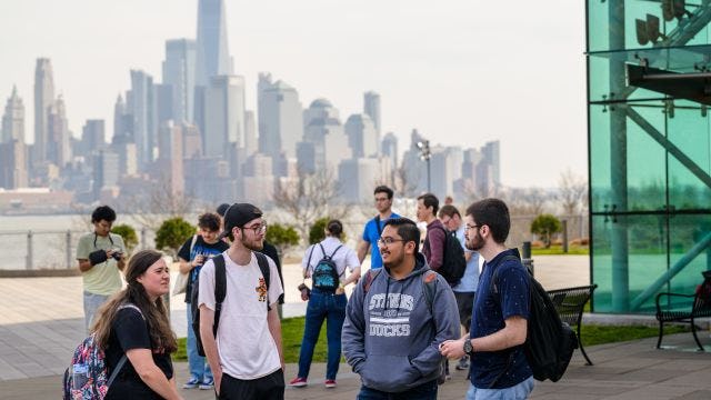 Students gathered at Babbio Patio overlooking the NYC skyline